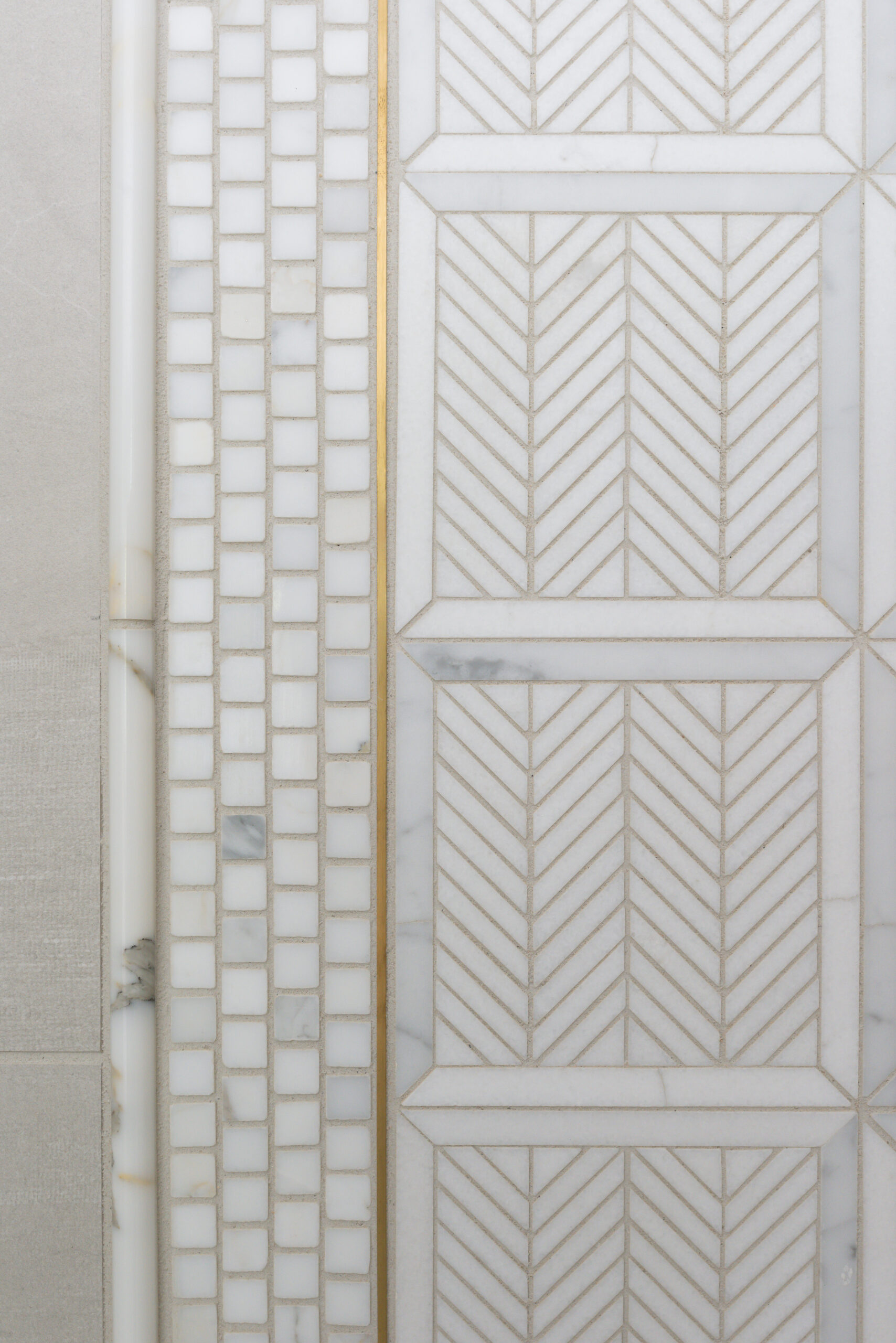 Light gray mosaic tile with golden accents