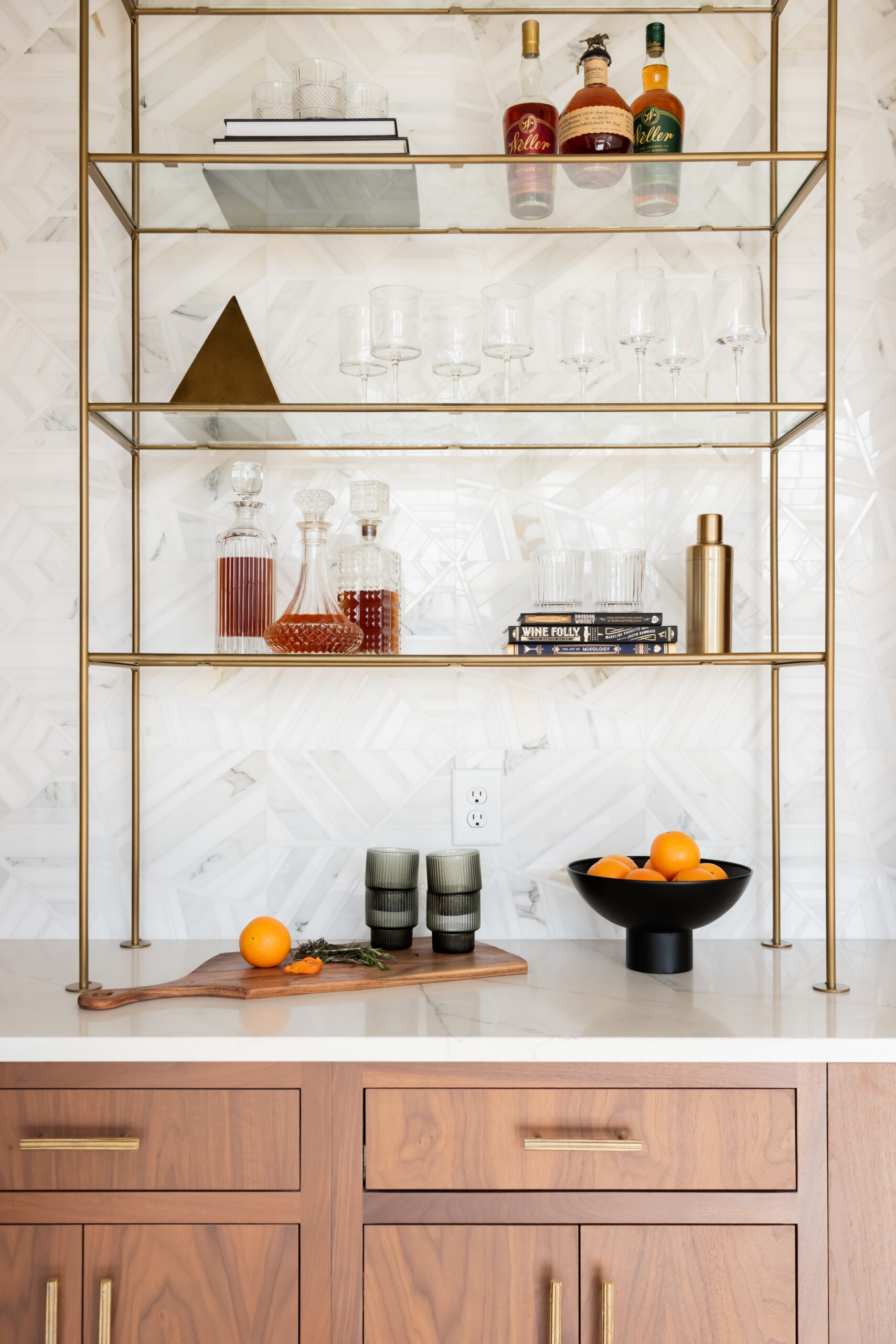 Double tower wood cabinetry with gold and glass bar shelving