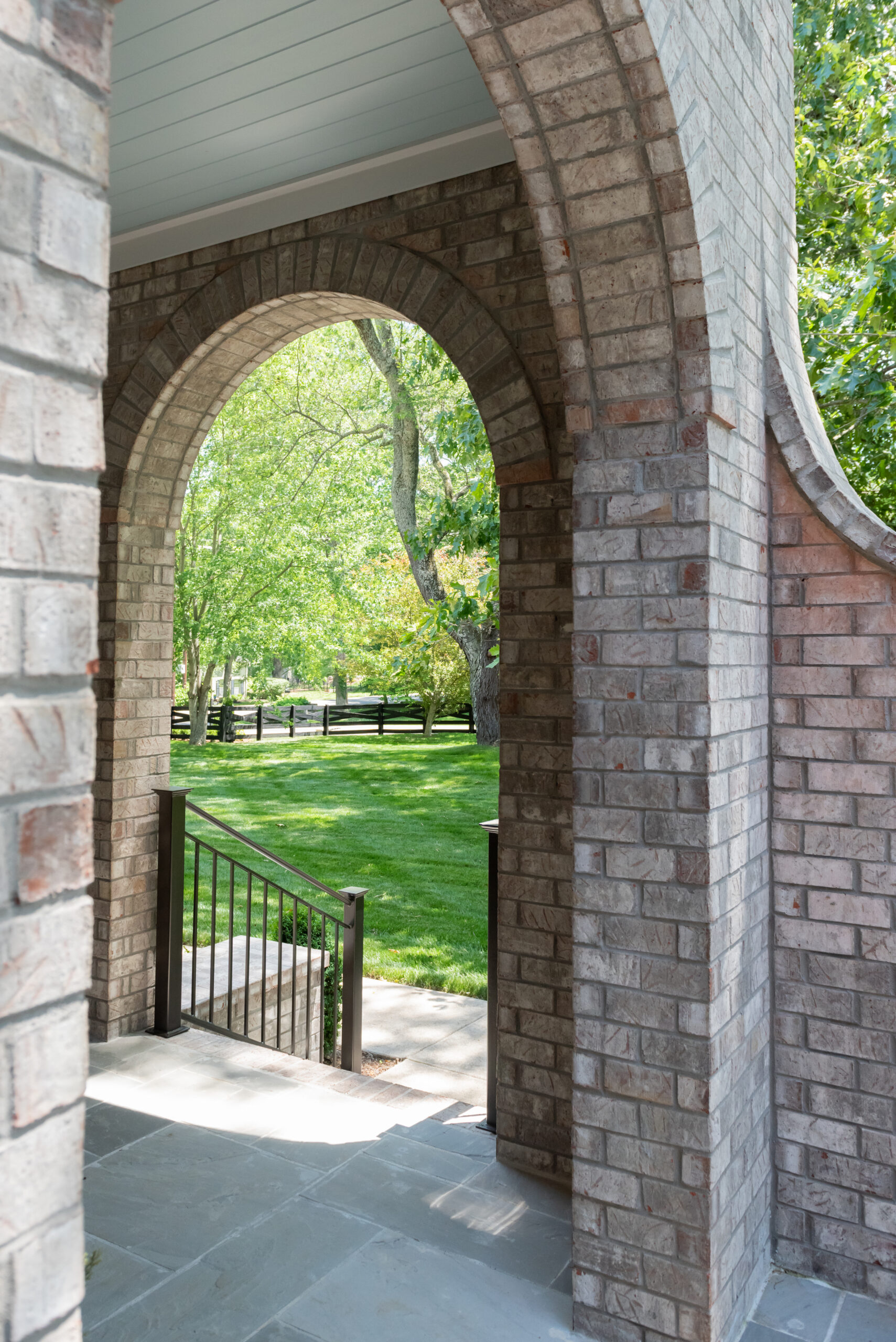 Brick arched front entry overlooking front lawn