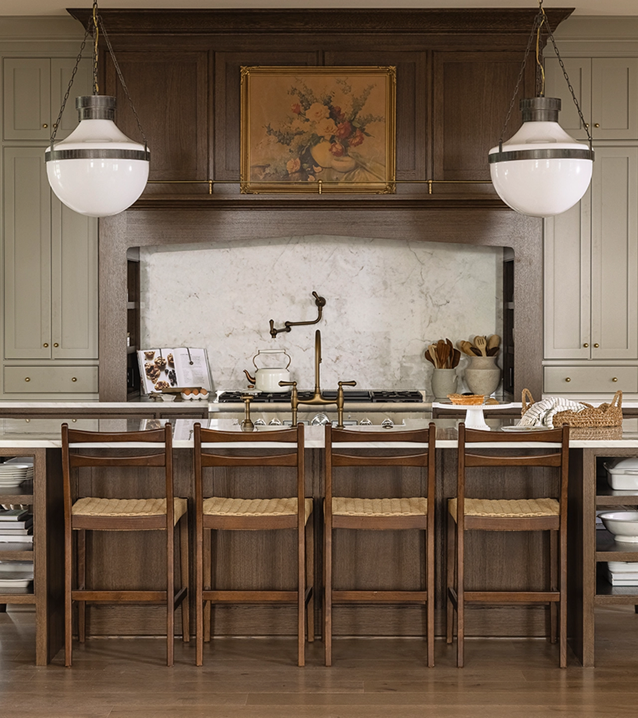 Kitchen with wood cabinets and two pedant lights over a large island with seating