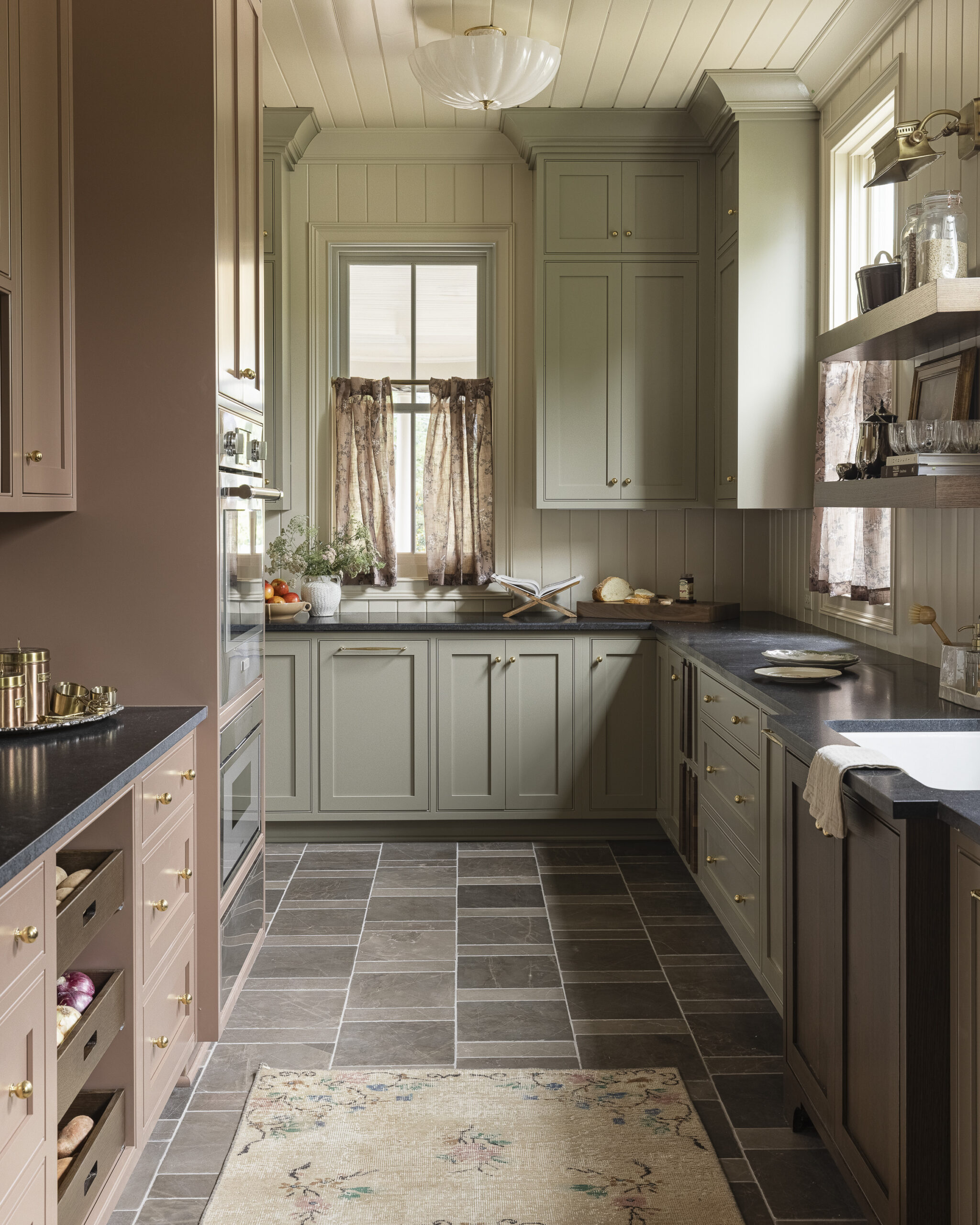 Pantry with floor to ceiling shelving bookcase, earth-toned cabinetry and walls, and floating shelves about the sink