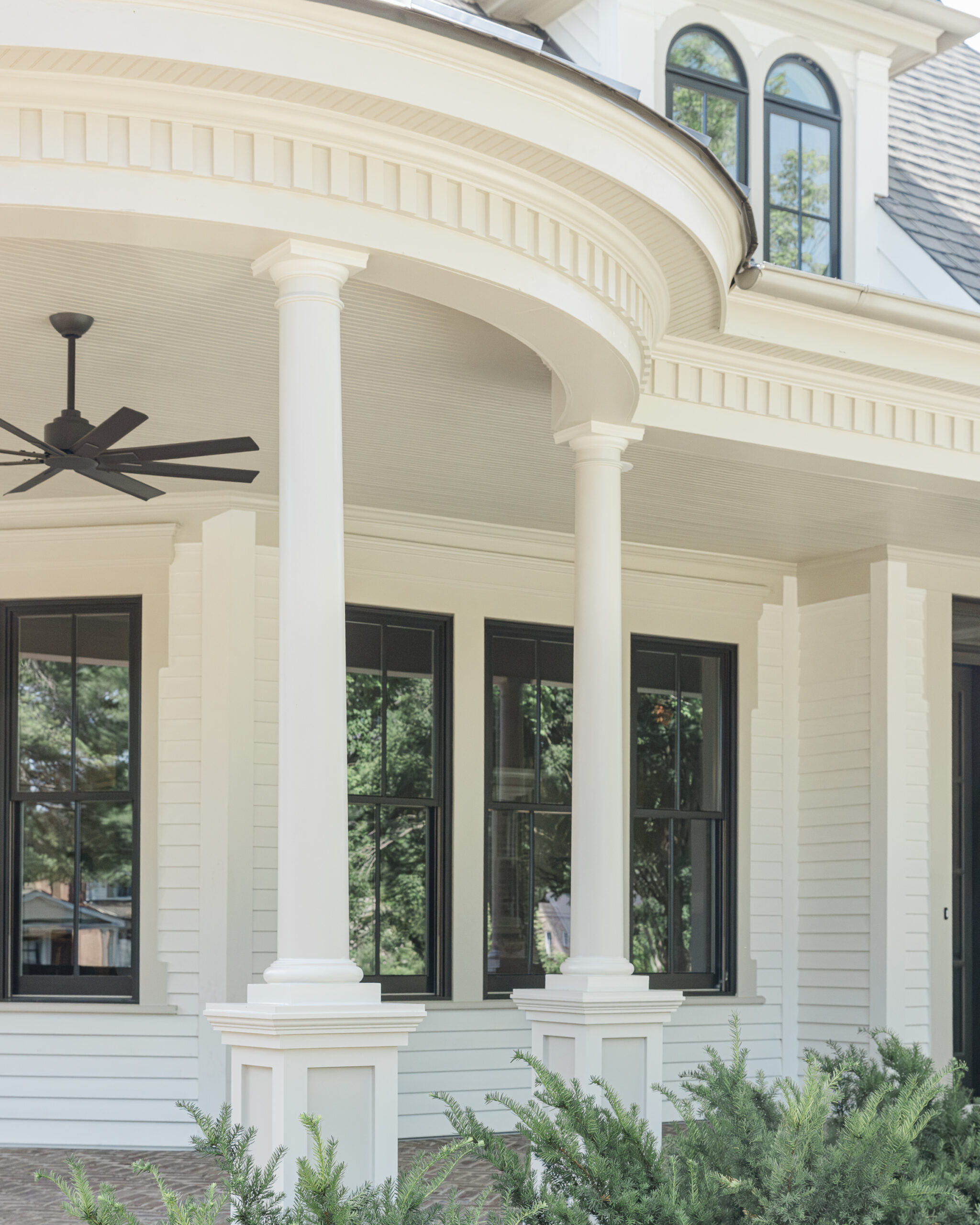 Victorian style home with a large wrap around porch with a circular extended front porch