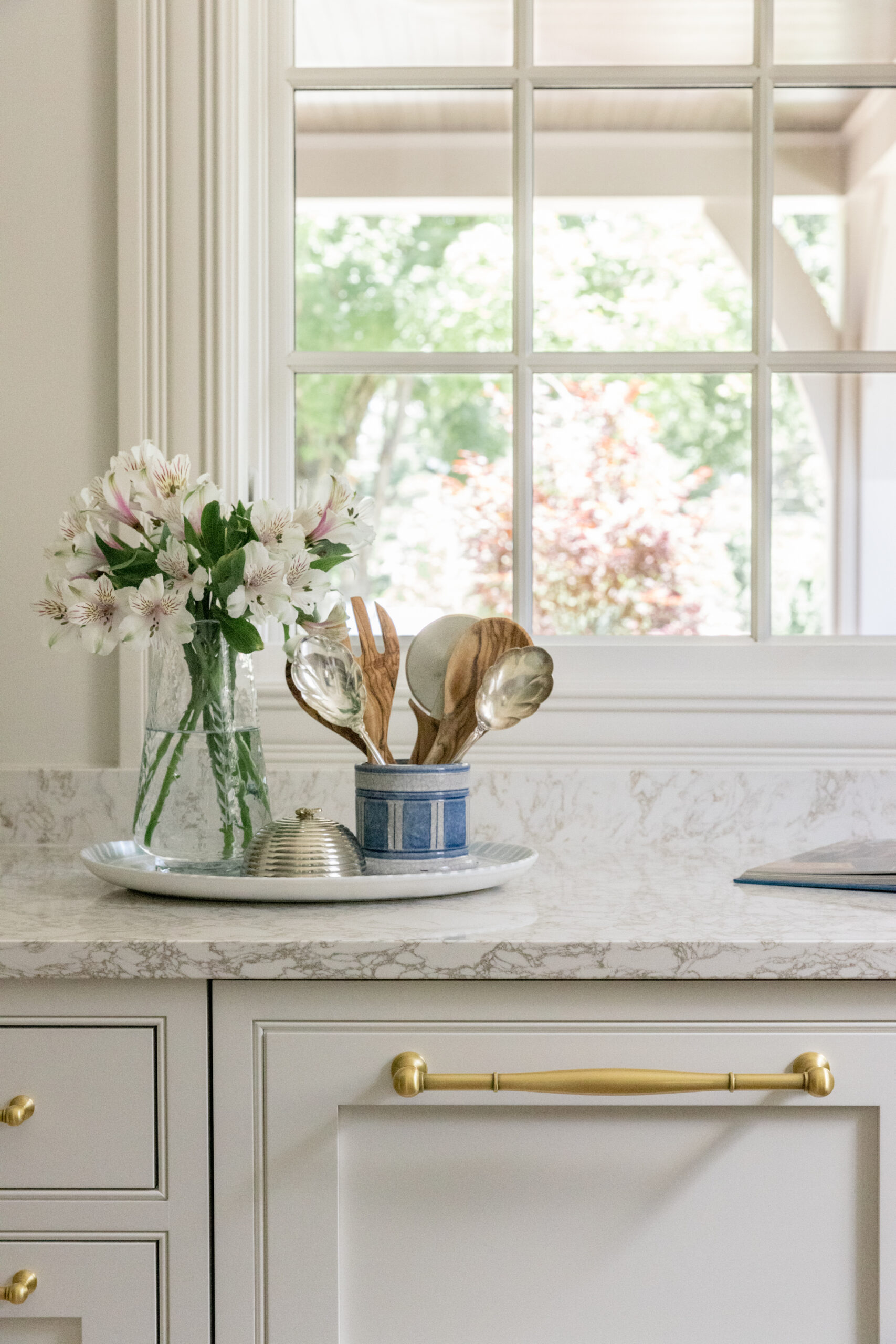 Pantry with white walls and cabinets and countertops with a window and pantry cabinet