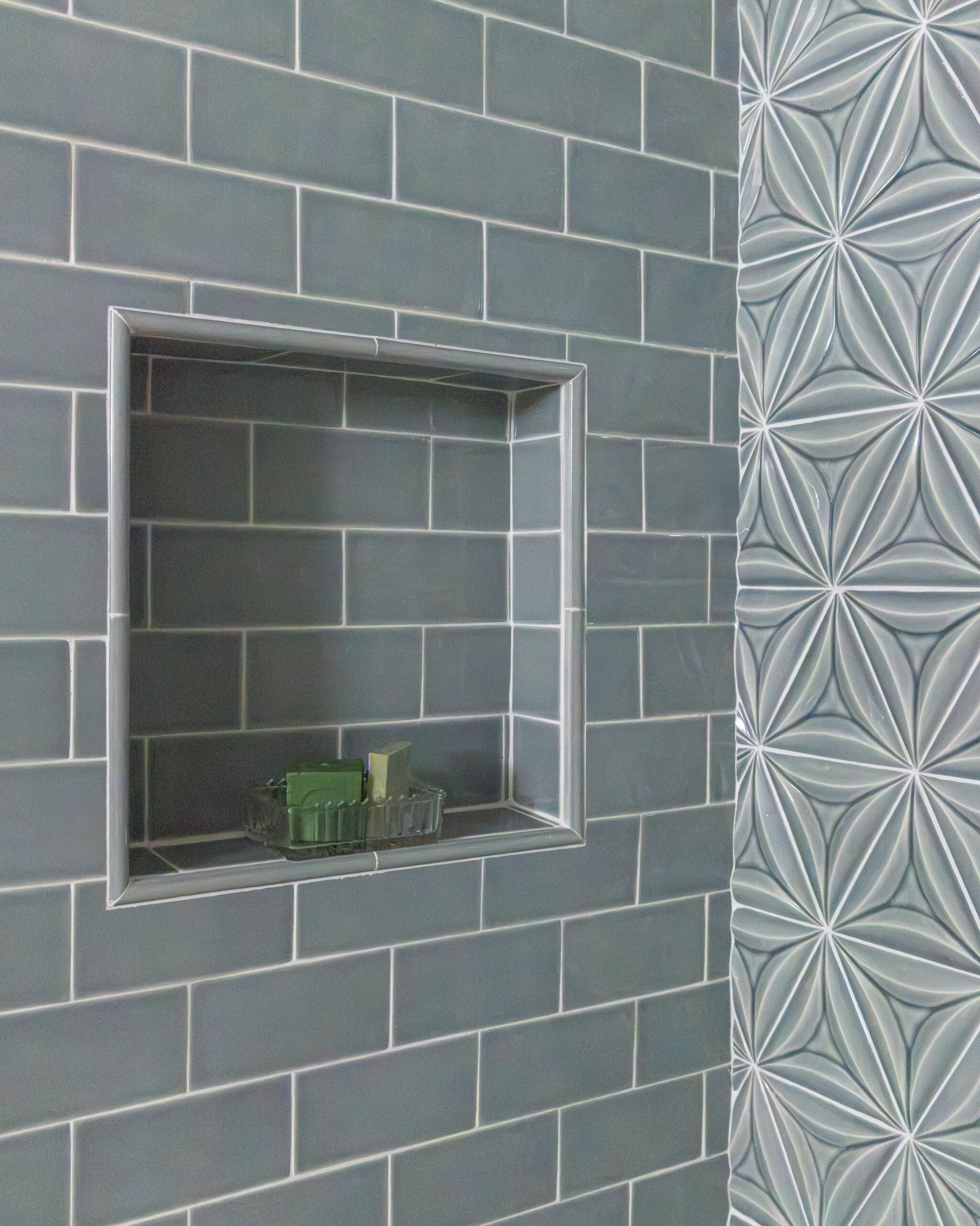 Blue subway tile with built-in niche on shower wall