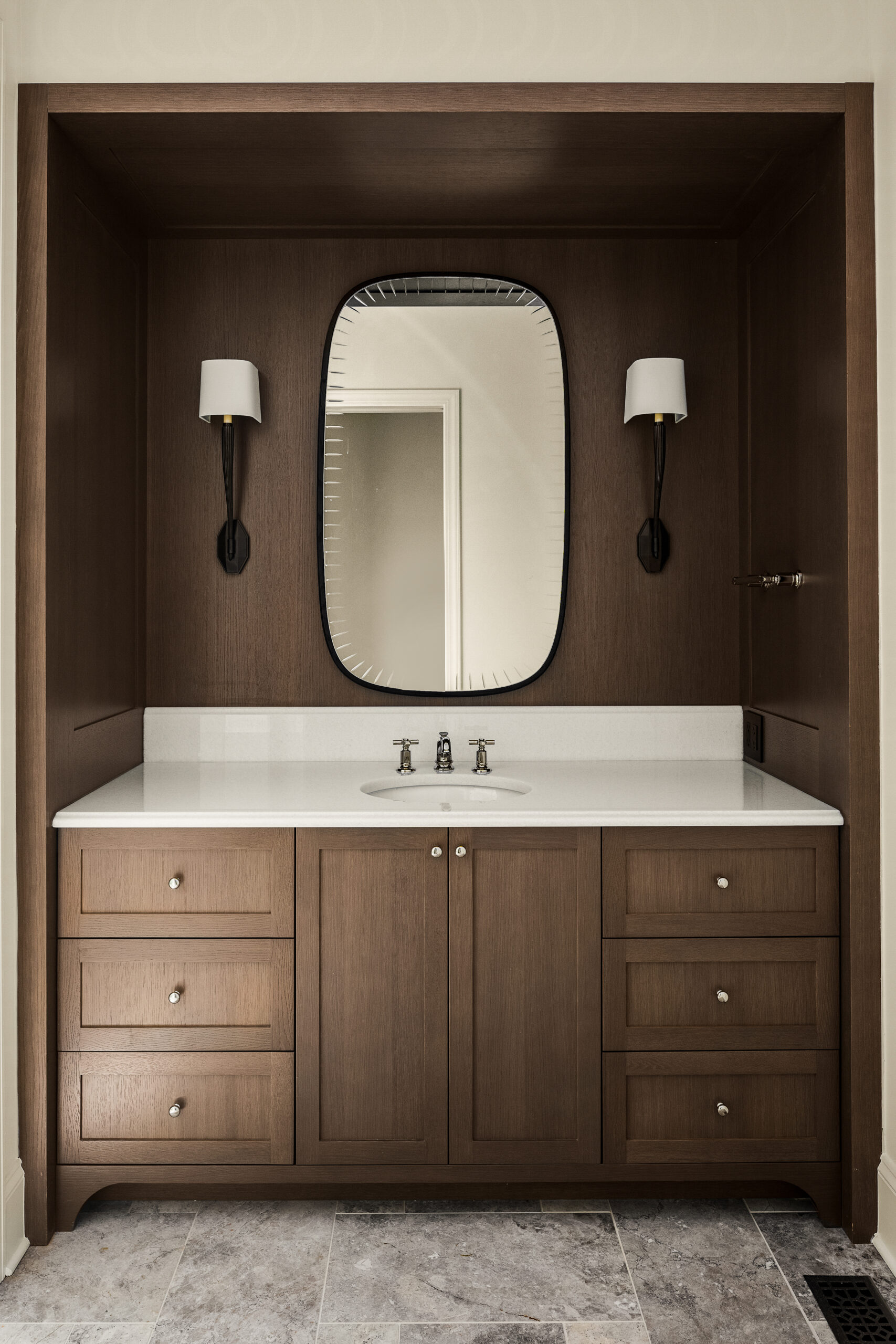 Bathroom with brown cabinetry, a freestanding tub, and tile flooring