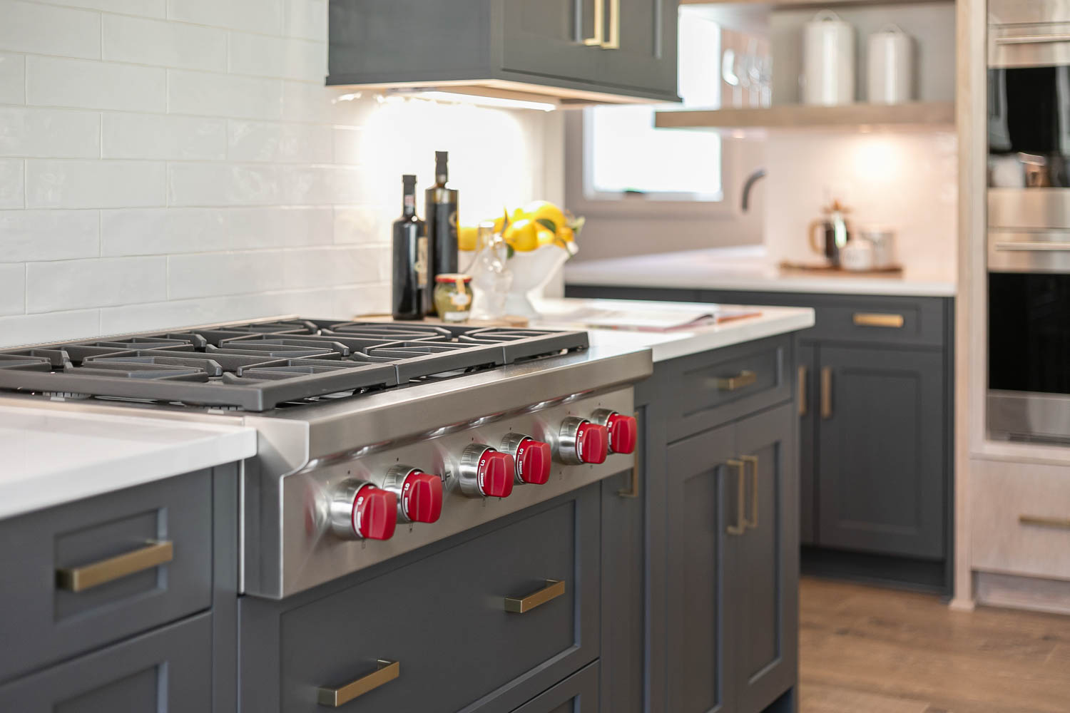 Kitchen range with red knobs and dark gray cabinet base