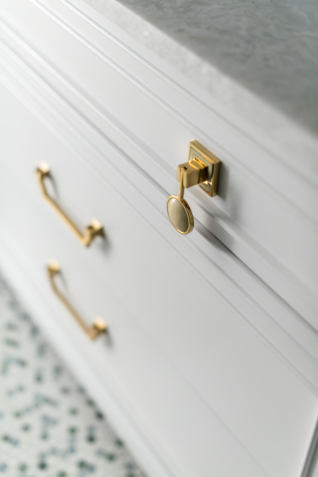 Blue and white penny tile with light gray vanity and gold drawer pulls