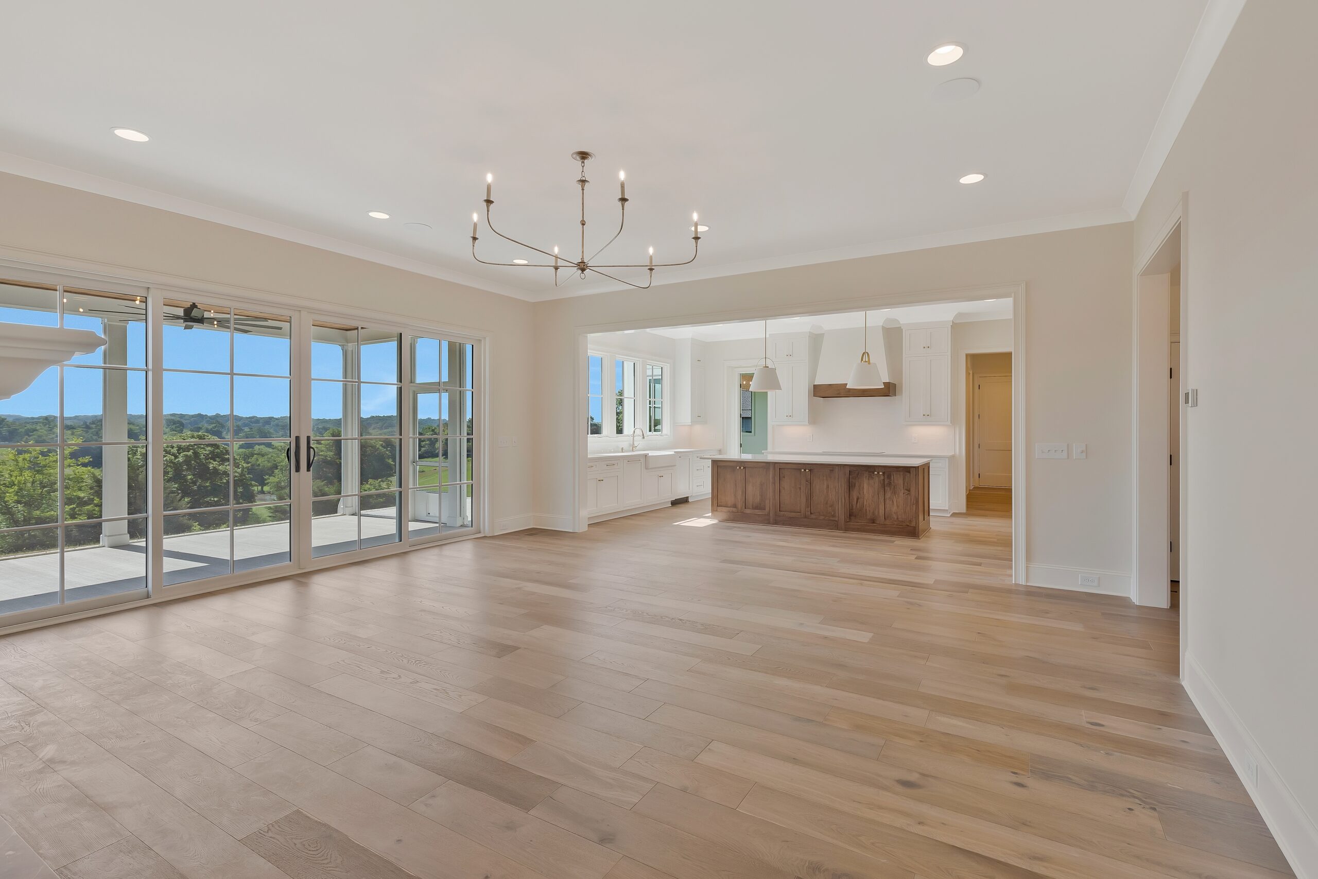 Family room with wall of windows and view of kitchen