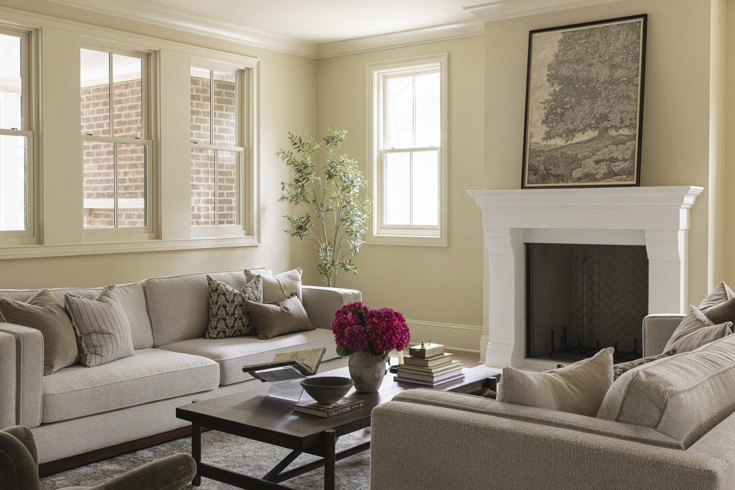 Family room with couches and coffee table and white plaster fireplace and mantle