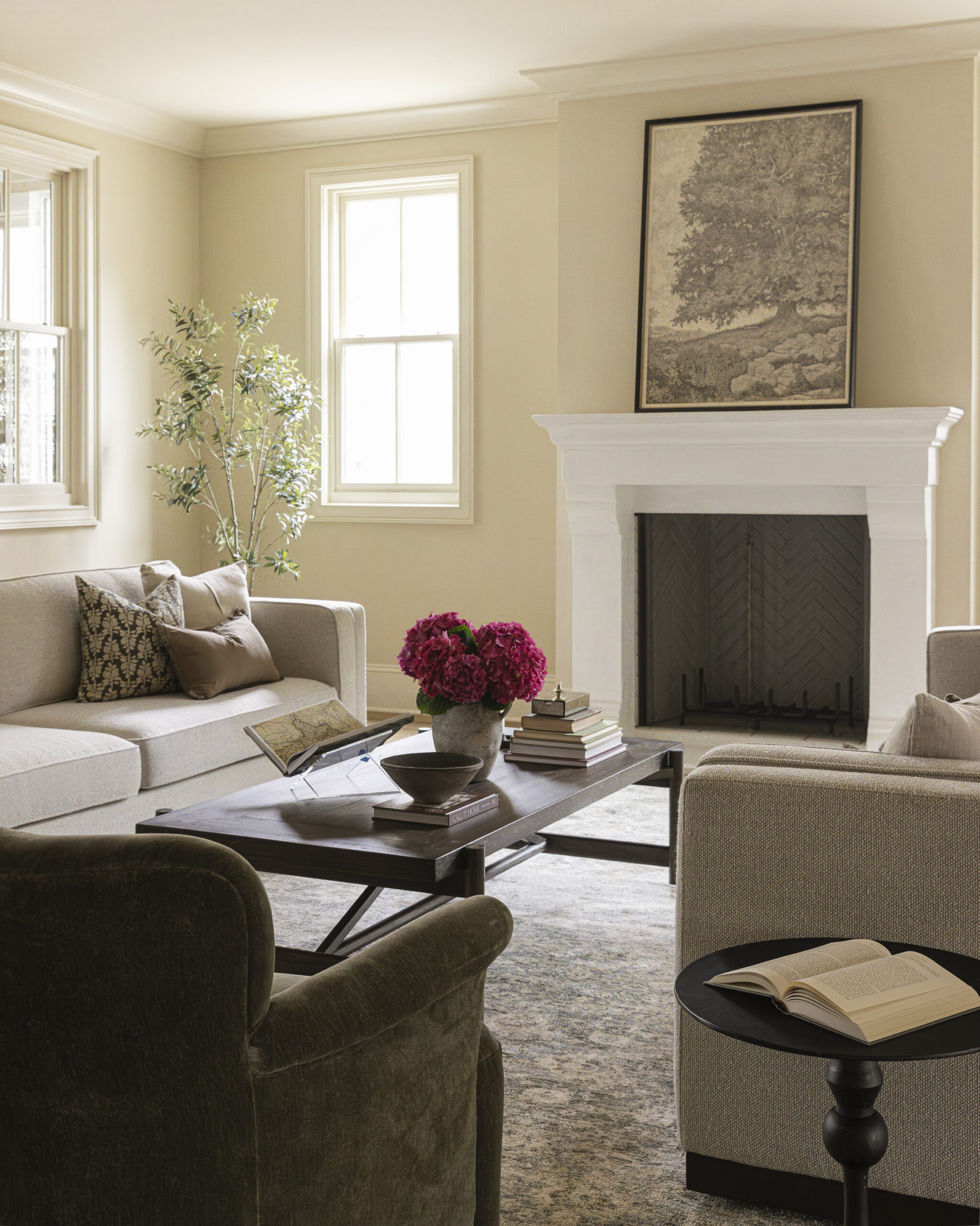 Family room with couches and coffee table and white plaster fireplace and mantle