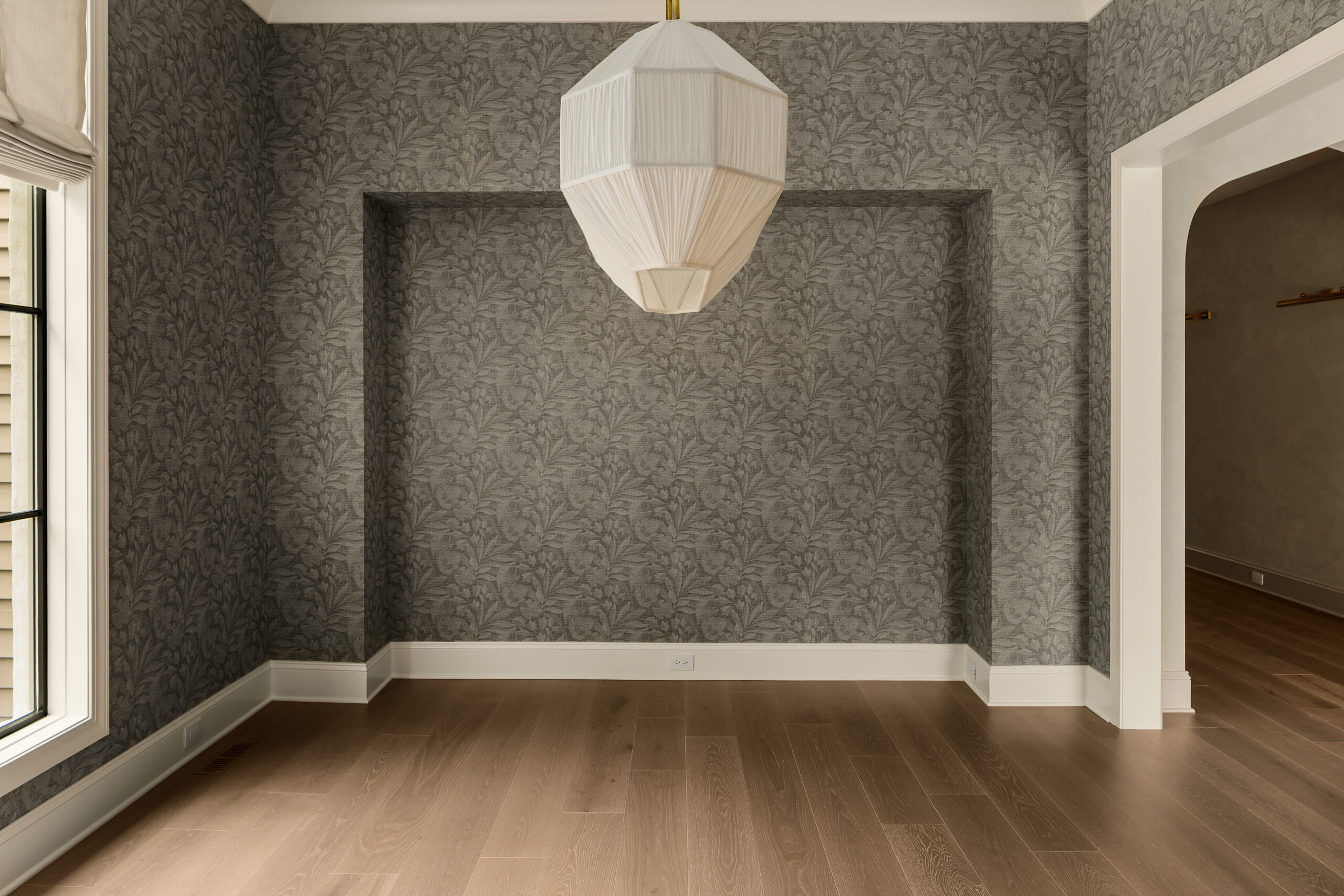 Muted tone wall paper with niche and chandlier