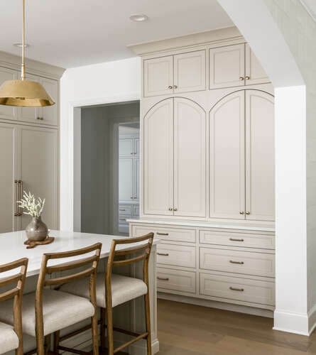 Island sitting area with view of taupe cabinetry and built-ins